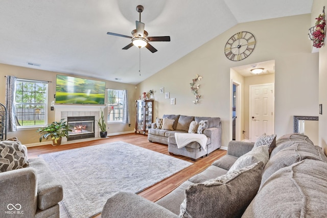 1896 Central Park Blvd W, Greenwood, IN 46143 - living room featuring lofted ceiling, ceiling fan, wood finished floors, and a tile fireplace