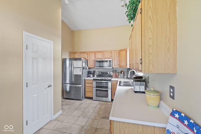 1896 Central Park Blvd W, Greenwood, IN 46143 - kitchen with stainless steel appliances, light brown cabinets, light countertops, light tile patterned floors, and high vaulted ceiling