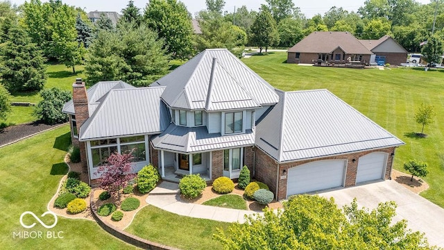 4416 Lakeshore Dr, Kokomo, IN 46901 - view of front of home with brick siding, a porch, a standing seam roof, a front lawn, and driveway