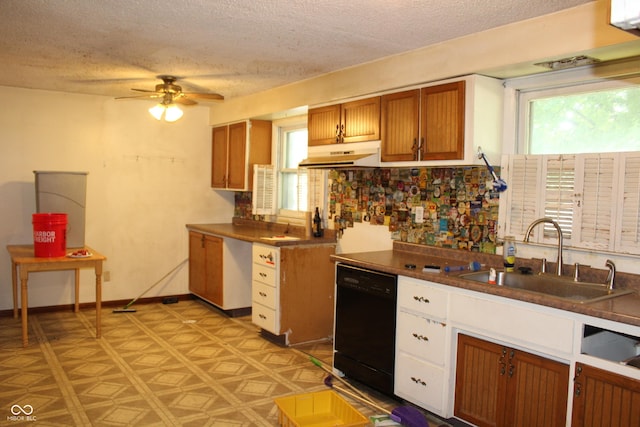 515 Hawthorne Ave, Anderson, IN 46011 - kitchen featuring black dishwasher, under cabinet range hood, a textured ceiling, plenty of natural light, and brown cabinetry