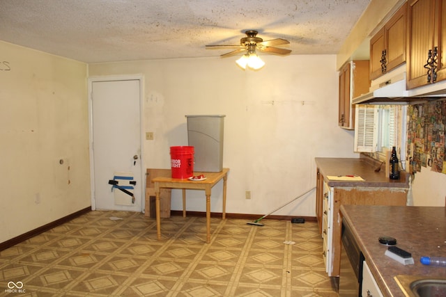 515 Hawthorne Ave, Anderson, IN 46011 - kitchen featuring brown cabinetry, a ceiling fan, a textured ceiling, dark countertops, and stainless steel dishwasher