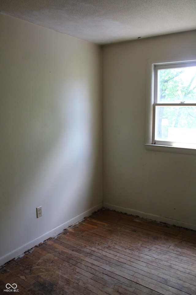 515 Hawthorne Ave, Anderson, IN 46011 - spare room with wood-type flooring and a textured ceiling