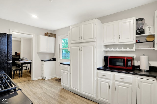 818 Vasbinder Dr, Chesterfield, IN 46017 - kitchen featuring freestanding refrigerator, white cabinetry, open shelves, and light wood finished floors
