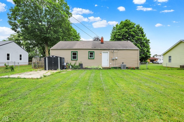 818 Vasbinder Dr, Chesterfield, IN 46017 - rear view of property with a storage unit and a chimney