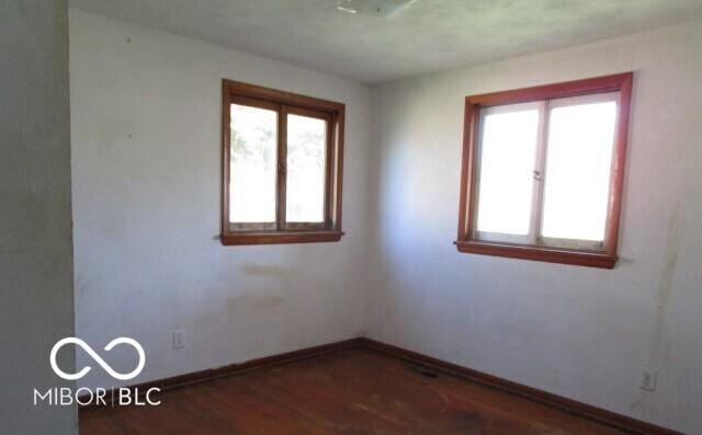 311 Fall Creek Dr, Anderson, IN 46013 - empty room featuring plenty of natural light and wood finished floors