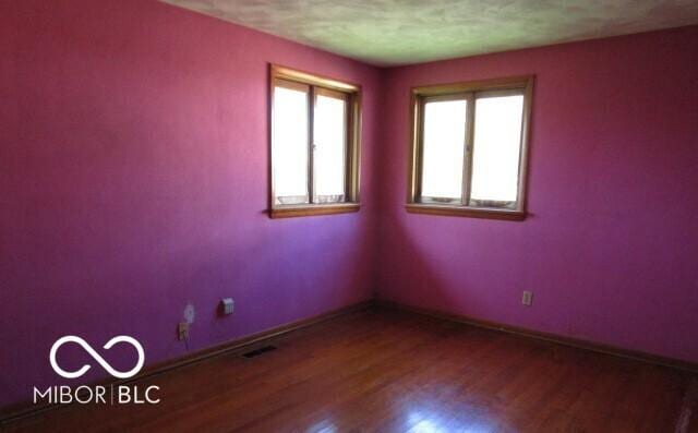 311 Fall Creek Dr, Anderson, IN 46013 - spare room with wood finished floors and baseboards