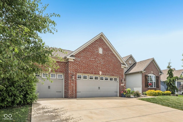 19281 Scofield Ridge Blvd, Westfield, IN 46074 - view of front facade with brick siding, driveway, a garage, and a shingled roof