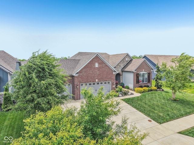 19281 Scofield Ridge Blvd, Westfield, IN 46074 - view of front facade with brick siding, a garage, a front yard, driveway, and a shingled roof