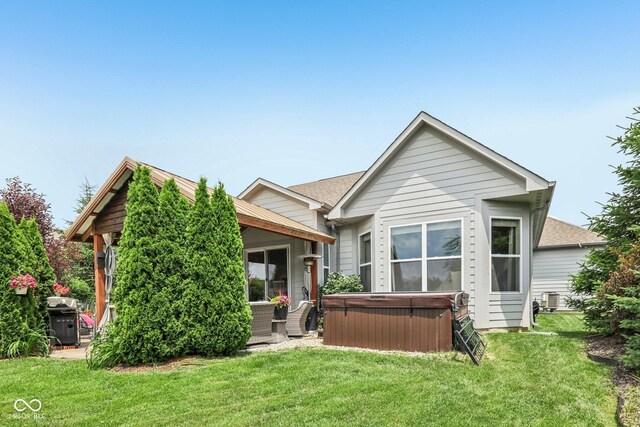 19281 Scofield Ridge Blvd, Westfield, IN 46074 - back of property featuring a hot tub, a yard, and a shingled roof