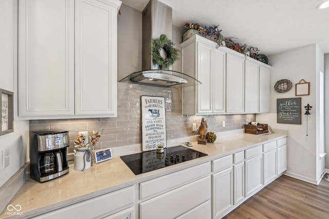19281 Scofield Ridge Blvd, Westfield, IN 46074 - kitchen featuring wall chimney range hood, black electric stovetop, white cabinetry, tasteful backsplash, and a textured ceiling