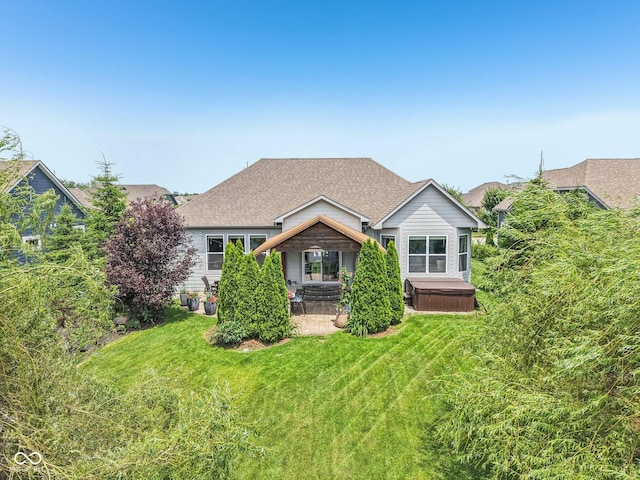19281 Scofield Ridge Blvd, Westfield, IN 46074 - rear view of house featuring a hot tub, a patio area, a yard, and a shingled roof