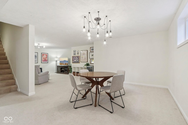 427 Quincy Pl, Westfield, IN 46074 - carpeted dining space featuring stairway and a chandelier