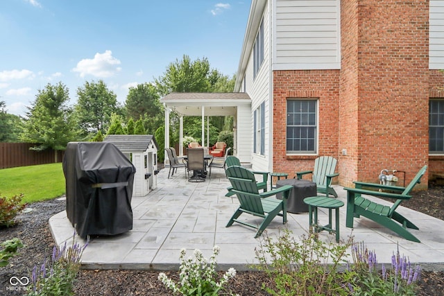 427 Quincy Pl, Westfield, IN 46074 - view of patio featuring a shed, an outdoor fire pit, area for grilling, and outdoor dining area