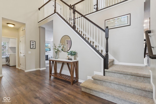 427 Quincy Pl, Westfield, IN 46074 - stairs with wood finished floors, washer / clothes dryer, a towering ceiling, and a fireplace