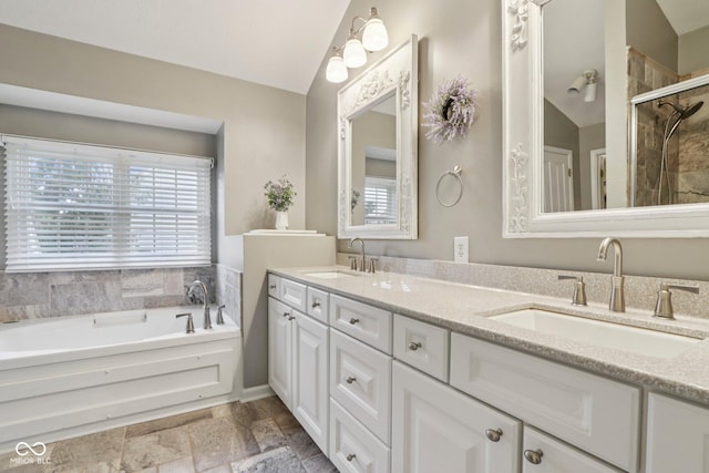 427 Quincy Pl, Westfield, IN 46074 - full bath with double vanity, a garden tub, vaulted ceiling, a shower stall, and stone finish flooring