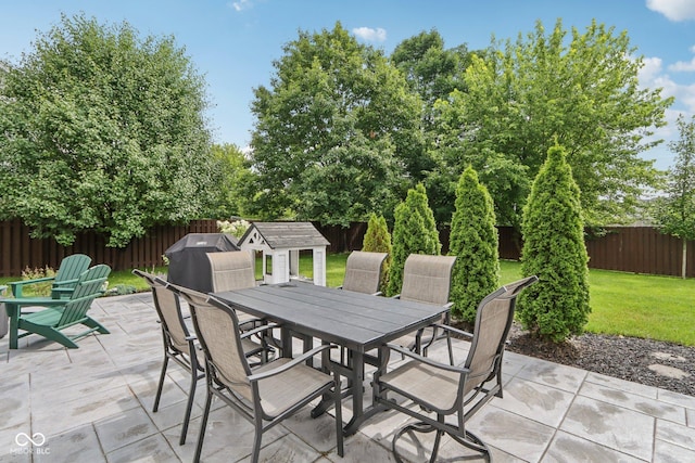 427 Quincy Pl, Westfield, IN 46074 - fenced backyard with a patio area, outdoor dining area, a shed, and area for grilling