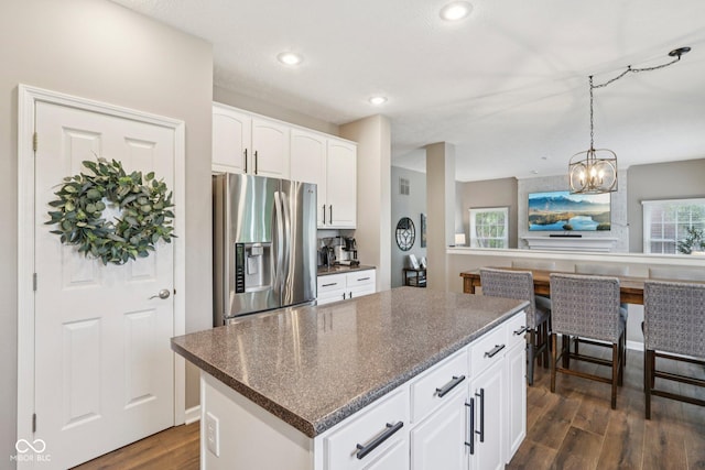 427 Quincy Pl, Westfield, IN 46074 - kitchen with stainless steel fridge, dark wood-style flooring, a kitchen island, white cabinetry, and recessed lighting