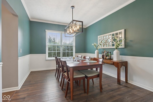427 Quincy Pl, Westfield, IN 46074 - dining room featuring a chandelier, a textured ceiling, dark wood-style flooring, crown molding, and a wainscoted wall