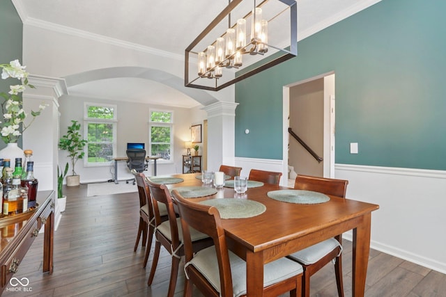 427 Quincy Pl, Westfield, IN 46074 - dining space featuring arched walkways, ornate columns, dark wood-type flooring, stairs, and crown molding