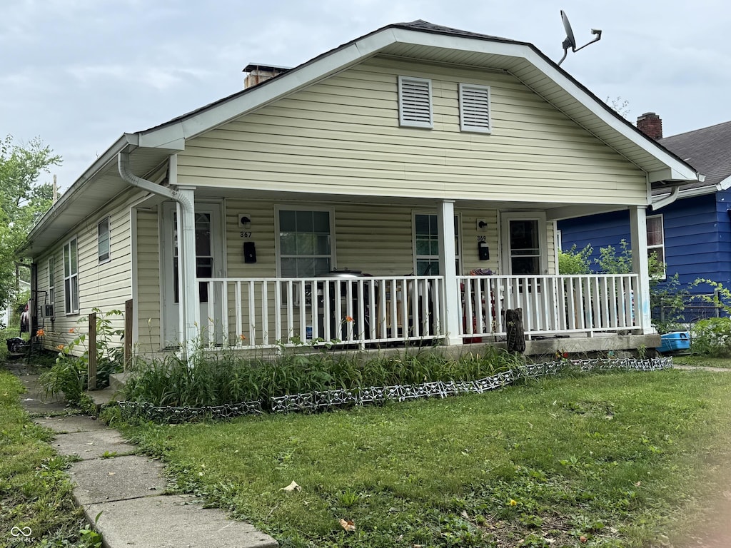 367 S Butler Ave, Indianapolis, IN 46219 - bungalow-style home featuring covered porch and a front yard