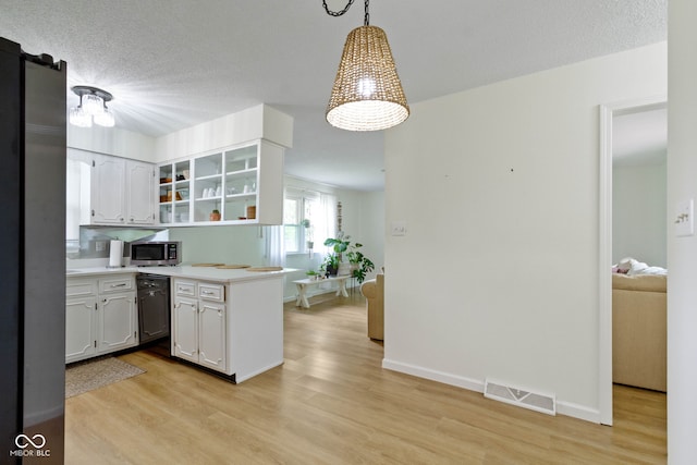 3841 Meridee Dr, Indianapolis, IN 46237 - kitchen with stainless steel microwave, a peninsula, light wood-type flooring, black dishwasher, and a textured ceiling