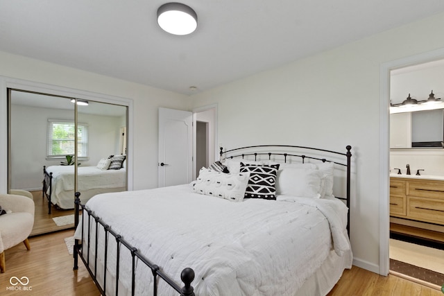3841 Meridee Dr, Indianapolis, IN 46237 - bedroom with light wood-style flooring, a closet, and connected bathroom