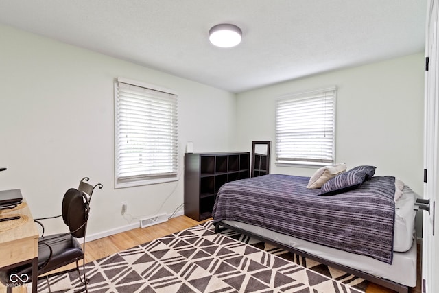 3841 Meridee Dr, Indianapolis, IN 46237 - bedroom with multiple windows and wood finished floors