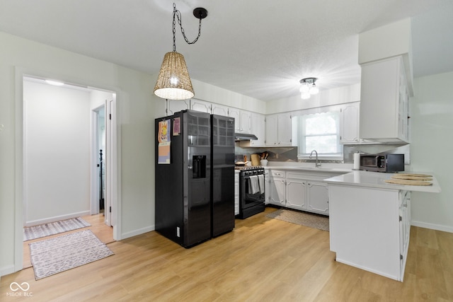 3841 Meridee Dr, Indianapolis, IN 46237 - kitchen featuring refrigerator with ice dispenser, gas stove, a peninsula, light countertops, and light wood-type flooring