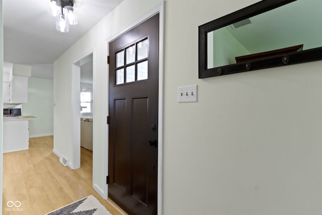 3841 Meridee Dr, Indianapolis, IN 46237 - foyer entrance with light wood-style floors and baseboards