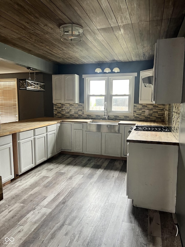 2244 Lafayette St, Anderson, IN 46012 - kitchen featuring decorative backsplash, wooden ceiling, light wood-style floors, cooktop, and wooden counters