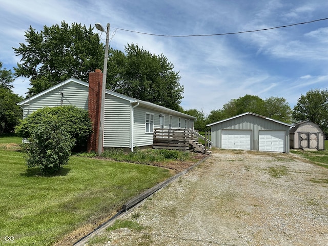 4673 S 400 W, New Palestine, IN 46163 - view of side of property with a garage, a chimney, a lawn, and a shed