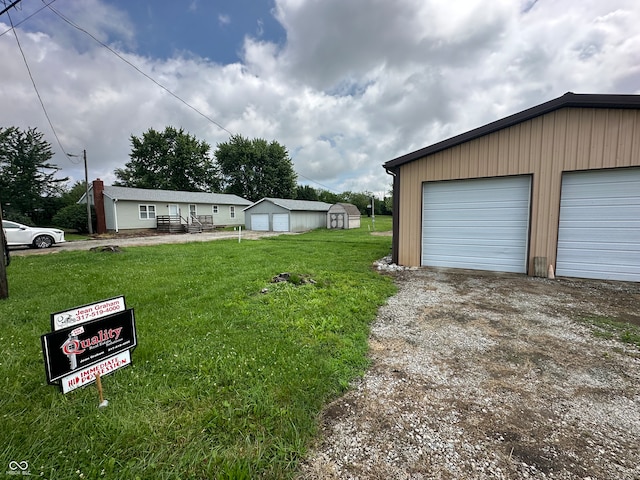 4673 S 400 W, New Palestine, IN 46163 - view of front of house with an outbuilding, a garage, a front yard, and driveway