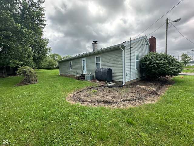 4673 S 400 W, New Palestine, IN 46163 - rear view of house featuring oil tank, a chimney, and a lawn