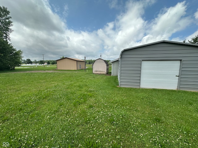 4673 S 400 W, New Palestine, IN 46163 - view of green lawn with an outbuilding and a garage