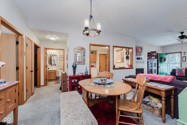 5515 Gateridge Ln, Indianapolis, IN 46237 - dining space with a chandelier, light colored carpet, ceiling fan, and washer / dryer