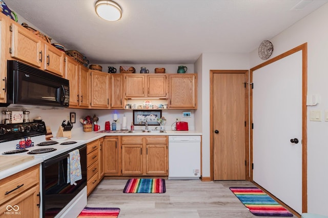 5515 Gateridge Ln, Indianapolis, IN 46237 - kitchen with black microwave, white dishwasher, range with electric stovetop, light countertops, and light wood-style floors