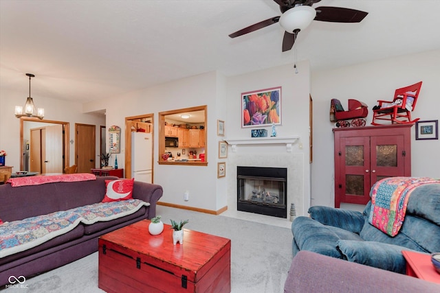5515 Gateridge Ln, Indianapolis, IN 46237 - living area with carpet, a ceiling fan, a fireplace with flush hearth, and a chandelier