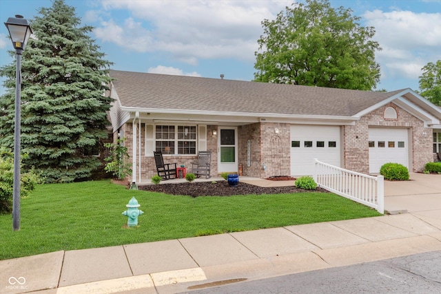 5515 Gateridge Ln, Indianapolis, IN 46237 - single story home with covered porch, brick siding, an attached garage, concrete driveway, and a front yard
