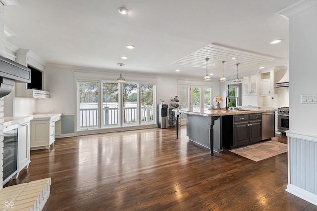 4443 Mallard Pt, Columbus, IN 47201 - kitchen with dishwasher, dark wood-style flooring, crown molding, a center island with sink, and light stone countertops