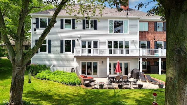 4443 Mallard Pt, Columbus, IN 47201 - back of house featuring a yard, a patio, and a shingled roof
