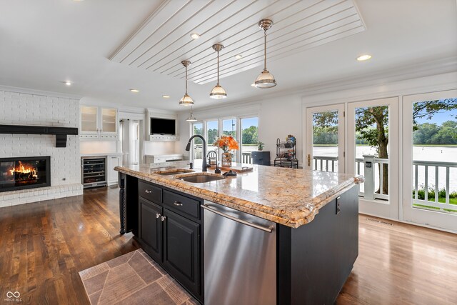 4443 Mallard Pt, Columbus, IN 47201 - kitchen featuring dishwasher, beverage cooler, dark cabinetry, a fireplace, and dark wood-type flooring