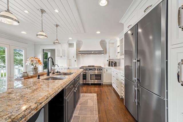 4443 Mallard Pt, Columbus, IN 47201 - kitchen with high quality appliances, range hood, white cabinetry, and recessed lighting