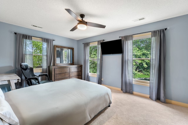 4443 Mallard Pt, Columbus, IN 47201 - bedroom with a textured ceiling, light carpet, a ceiling fan, and a desk