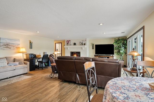 4443 Mallard Pt, Columbus, IN 47201 - living room with light wood finished floors, a large fireplace, and recessed lighting