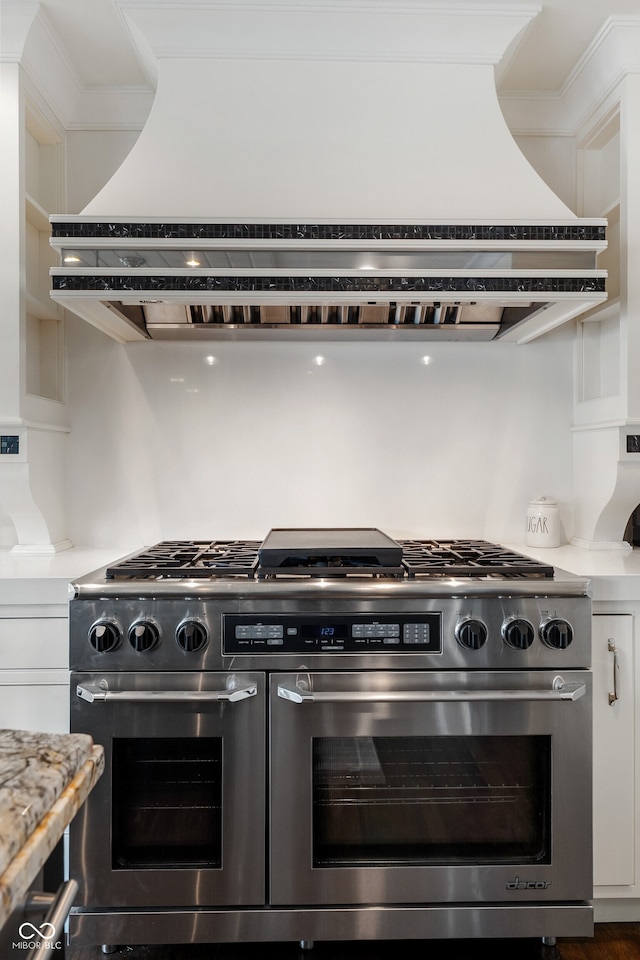 4443 Mallard Pt, Columbus, IN 47201 - kitchen with double oven range, custom exhaust hood, and white cabinetry