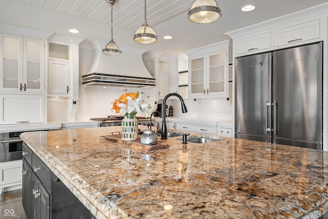4443 Mallard Pt, Columbus, IN 47201 - kitchen featuring appliances with stainless steel finishes, extractor fan, white cabinetry, recessed lighting, and glass insert cabinets