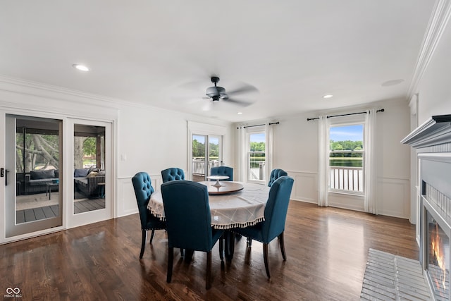4443 Mallard Pt, Columbus, IN 47201 - dining area featuring a fireplace with flush hearth, a ceiling fan, crown molding, dark wood finished floors, and a decorative wall