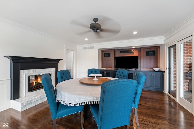 4443 Mallard Pt, Columbus, IN 47201 - dining area with ornamental molding, ceiling fan, dark wood-type flooring, a fireplace, and recessed lighting