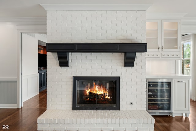 4443 Mallard Pt, Columbus, IN 47201 - detailed view of wine cooler, wood finished floors, a brick fireplace, and ornamental molding