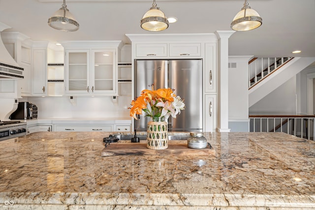 4443 Mallard Pt, Columbus, IN 47201 - kitchen featuring stainless steel refrigerator, white cabinets, glass insert cabinets, and decorative light fixtures